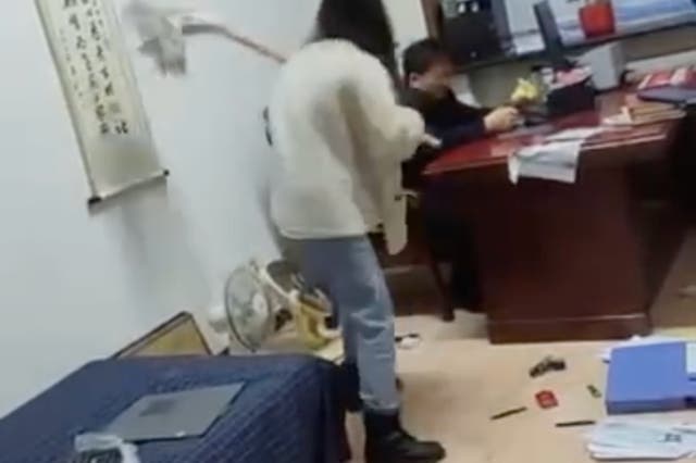 A government office worker in China went viral after she was seen in online video beating her boss with a mop. 