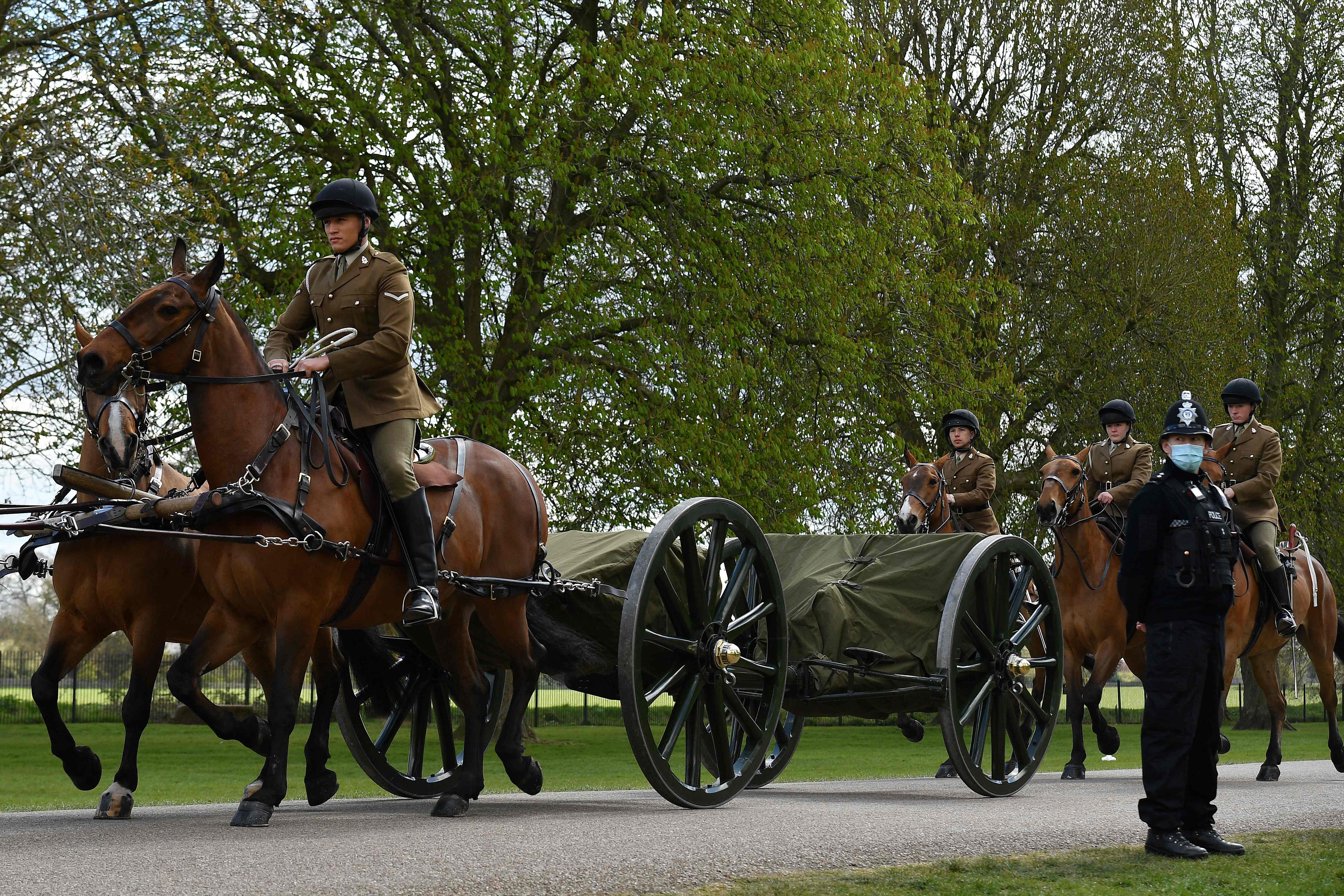 Members of the Household Cavalry Mounted Regiment ride their horses into the grounds of Windsor Castle in Windsor