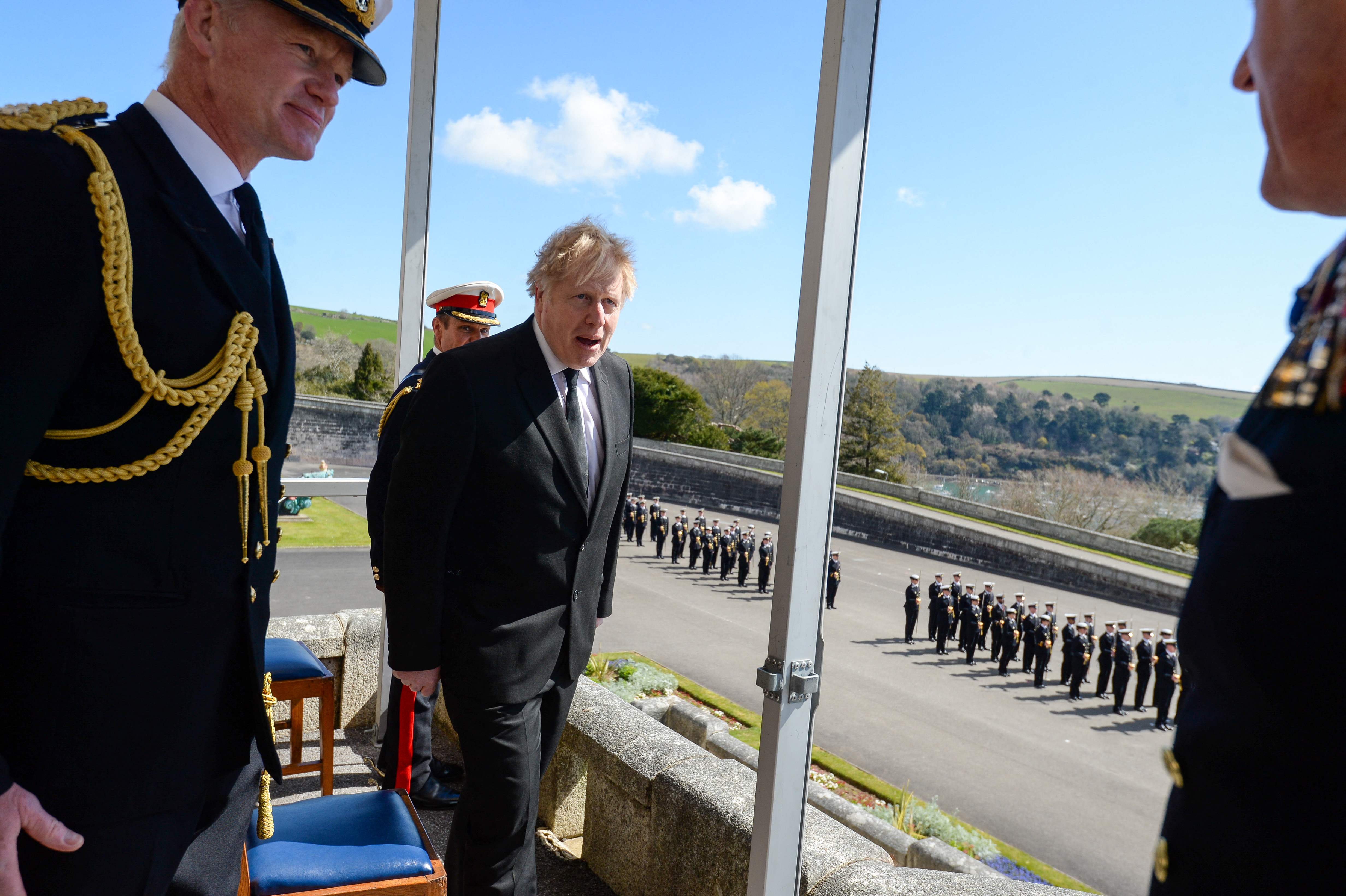 Boris Johnson (C) watches a Passing-out parade at Britannia Royal Naval College, in Dartmouth