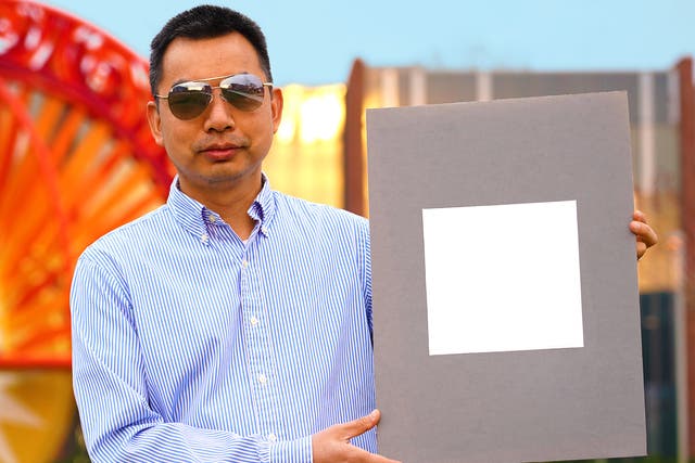 Developer Xiulin Ruan holds up a sample of the ‘whitest paint’ 