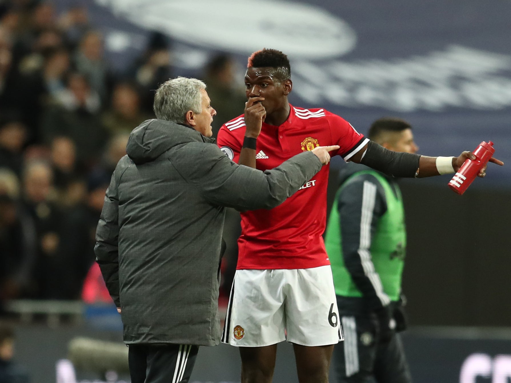 <p>Paul Pogba and Jose Mourinho speak on the touchline in 2018</p>
