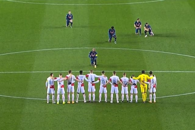 Arsenal striker Alexandre Lacazette takes a knee