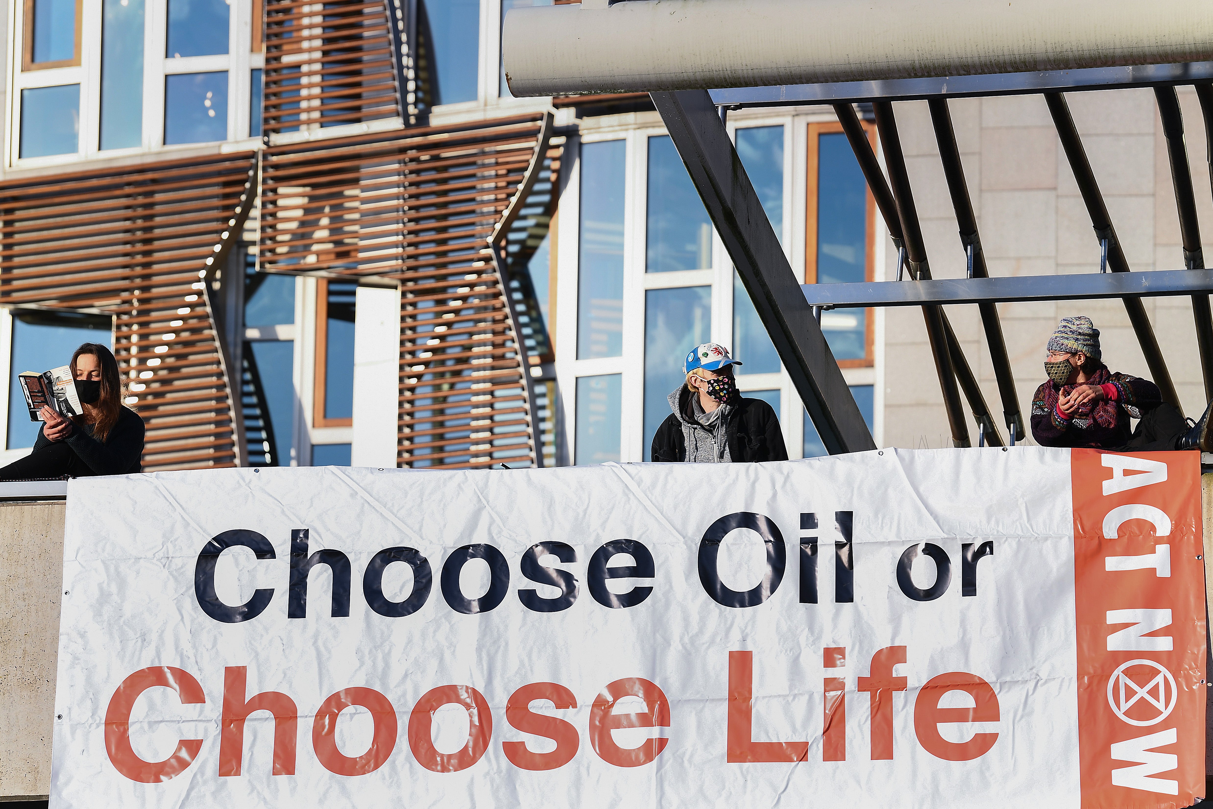 Extinction Rebellion activists protest on the roof of the Scottish parliament in October 2020