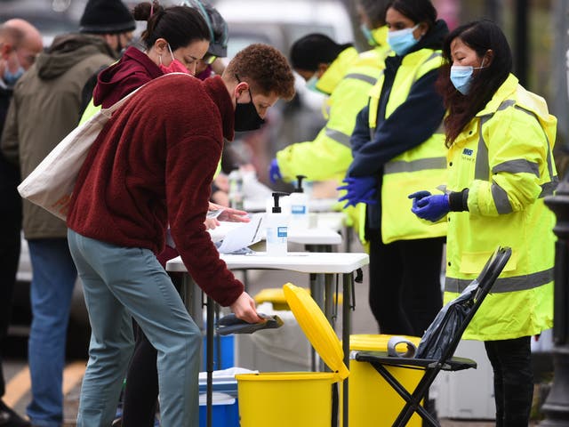 People take part in coronavirus surge testing on Clapham Common, south London