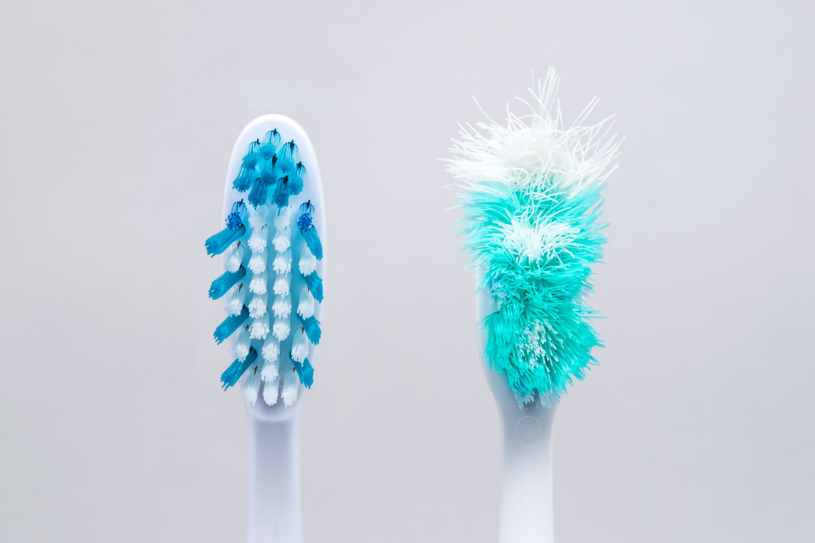 old and new toothbrushes isolated on a white backg