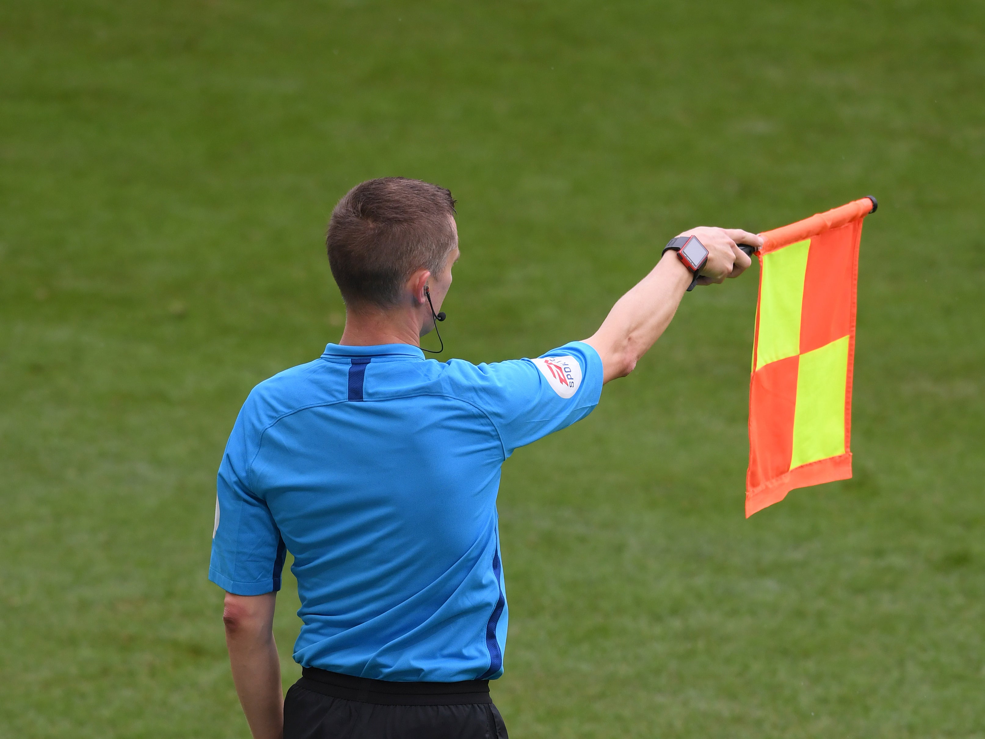 An assistant referee flags for offside