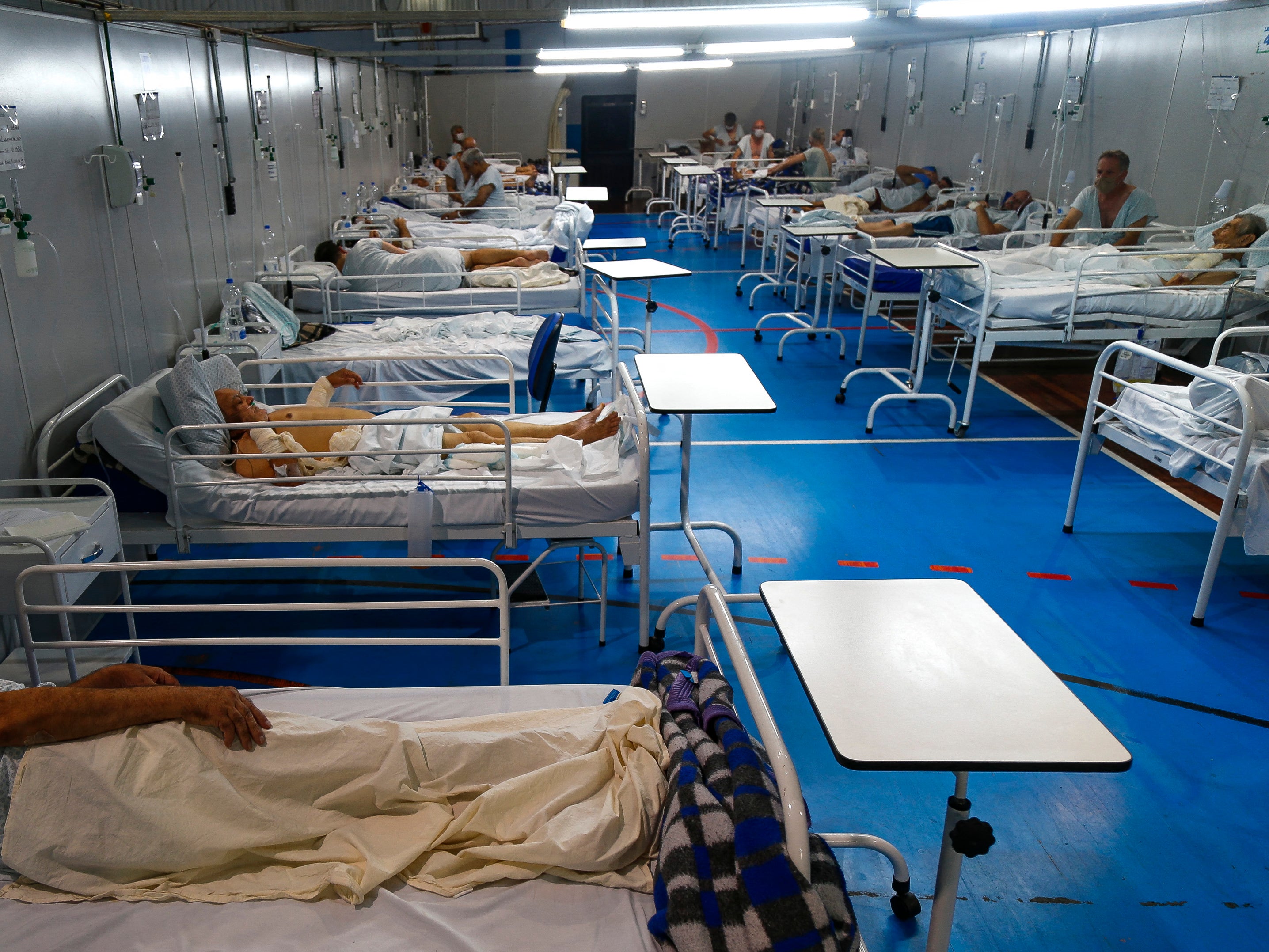 Covid patients are treated at a field hospital set up at a sports gym, in Santo Andre, Sao Paulo state, Brazil, in March