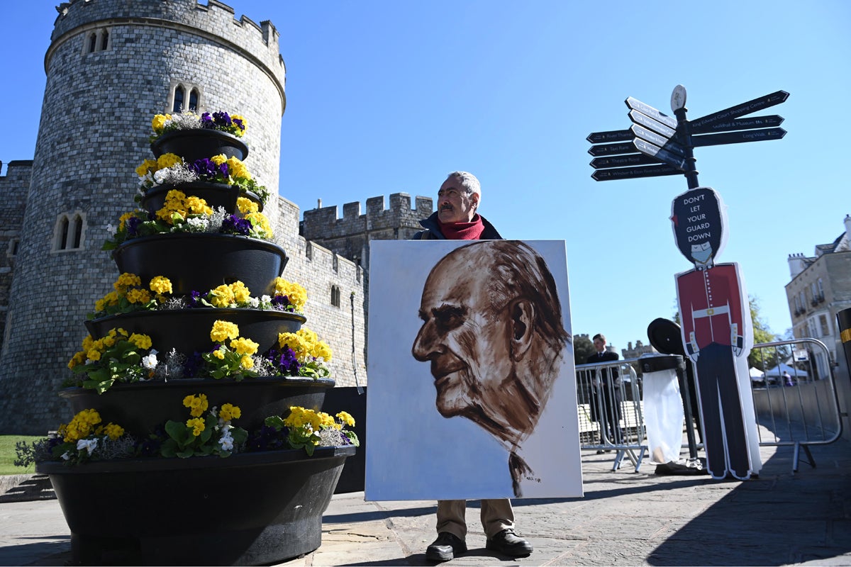 Artist Kaya Marr holds a portrait of Britain's Prince Philip outside Windsor Castle in Windsor