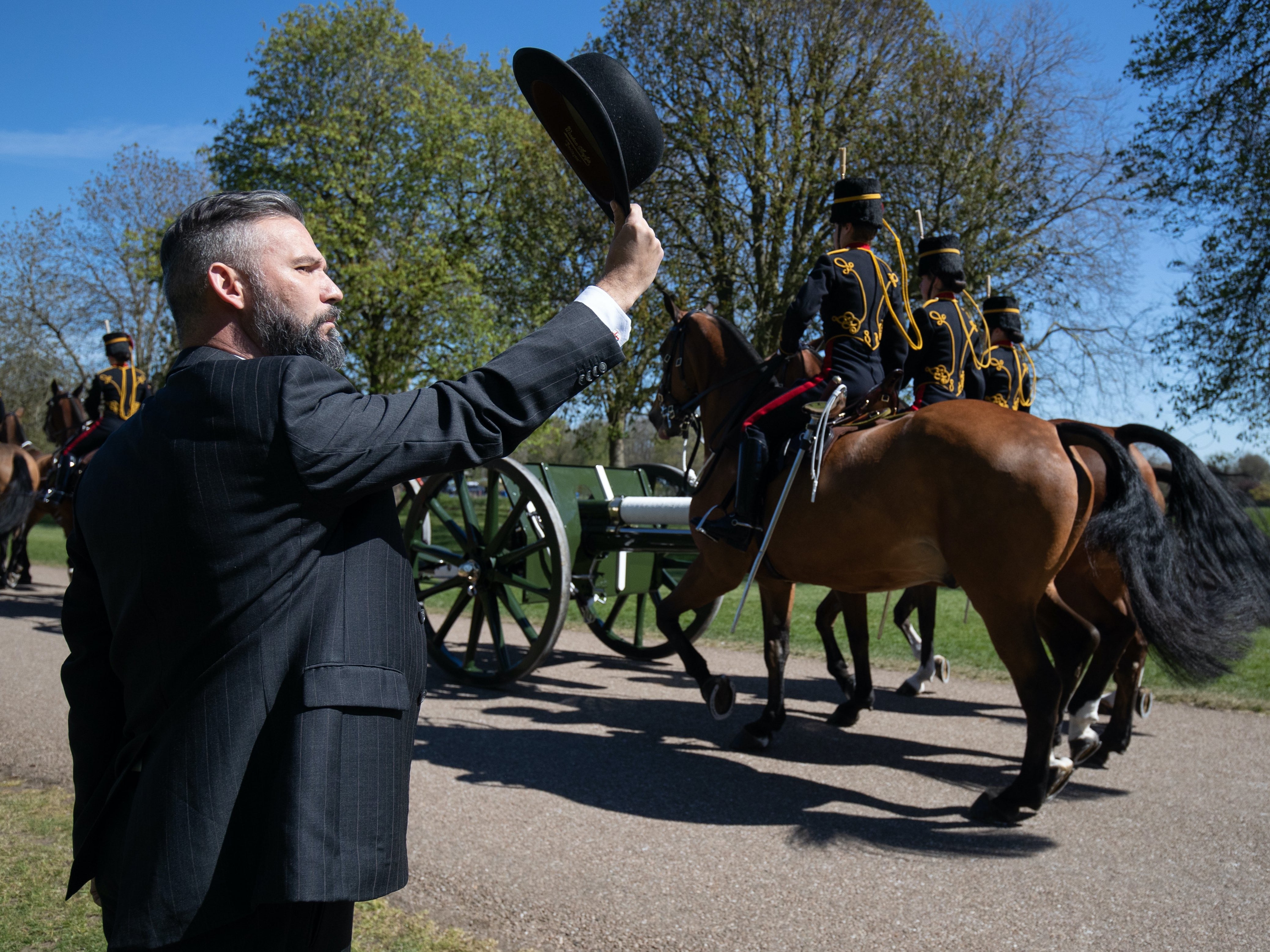 Man salutes the King’s Troop Royal Horse Artillery at they approach Windsor Castle