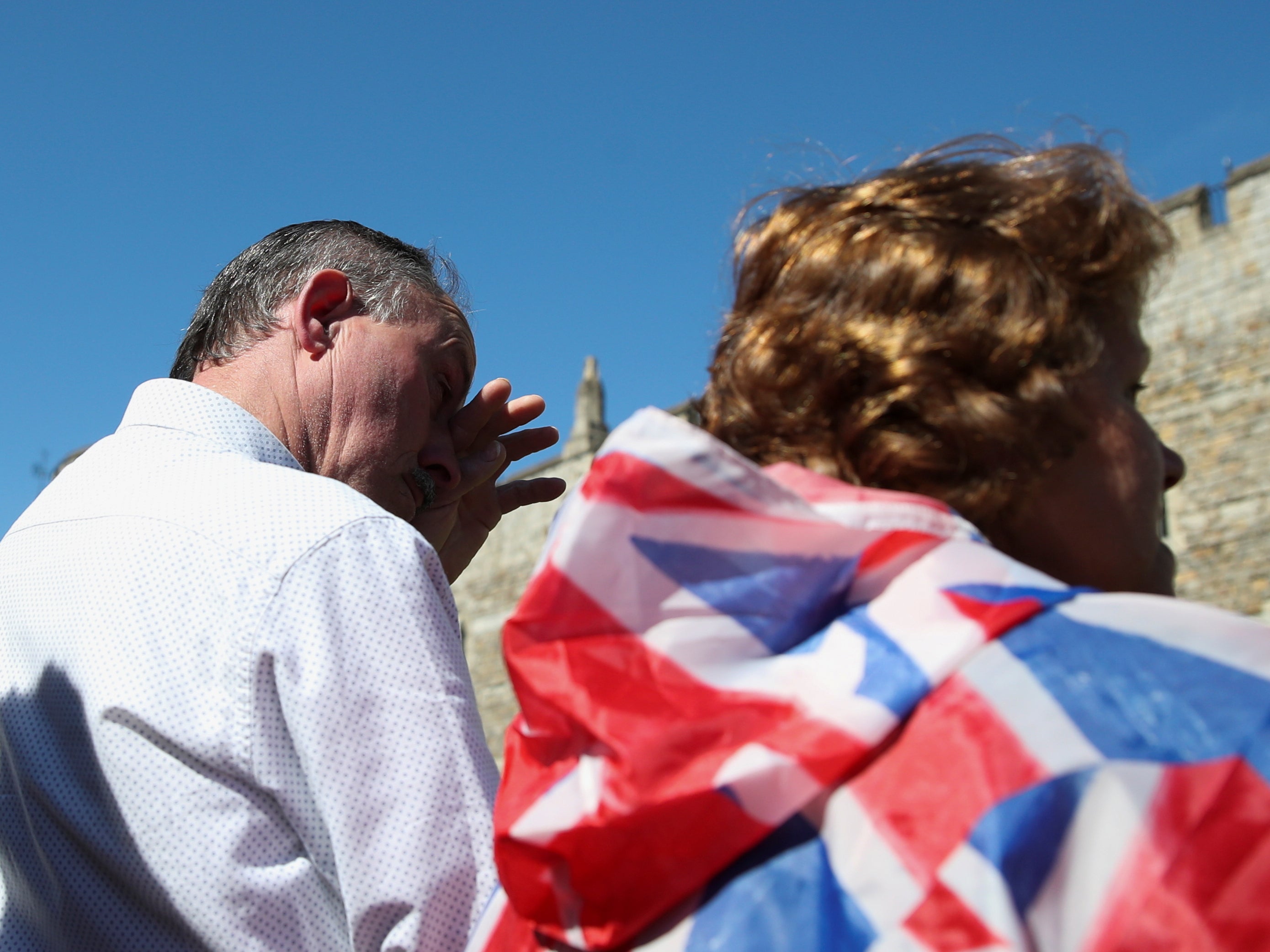 A man wipes his tears during a minute's silence for the funeral of Britain's Prince Philip