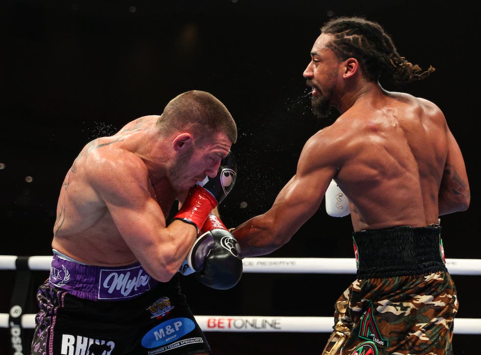 <p>Liam Williams takes a punch from Demetrius Andrade</p>