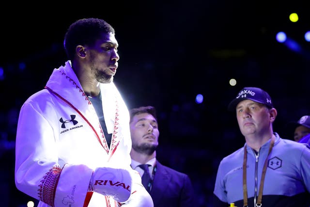 Anthony Joshua prepares in the ring as his trainer Robert McCracken looks on