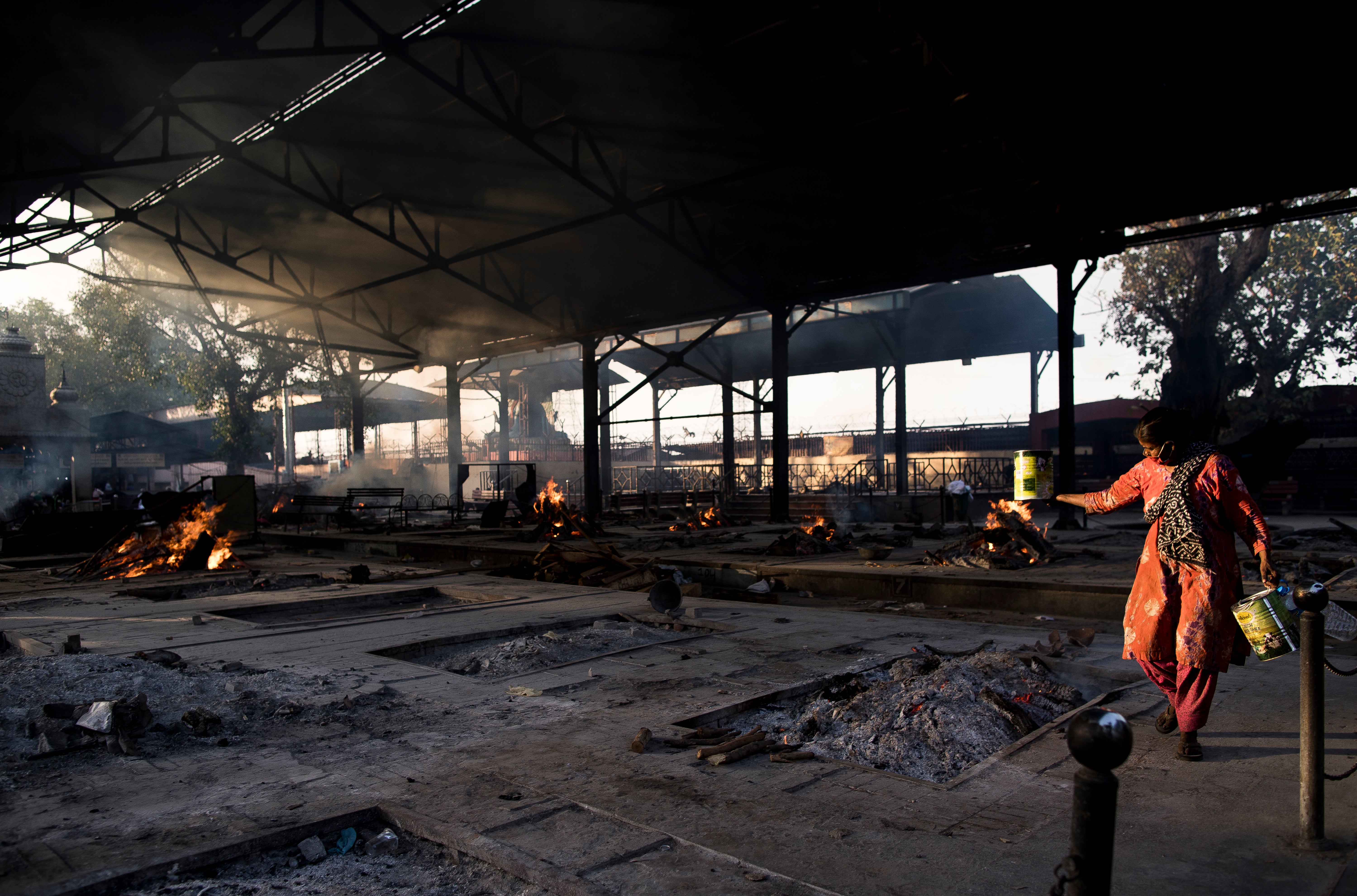 Multiple burning pyres of patients who died of the Covid-19 infections at a crematorium in New Delhi