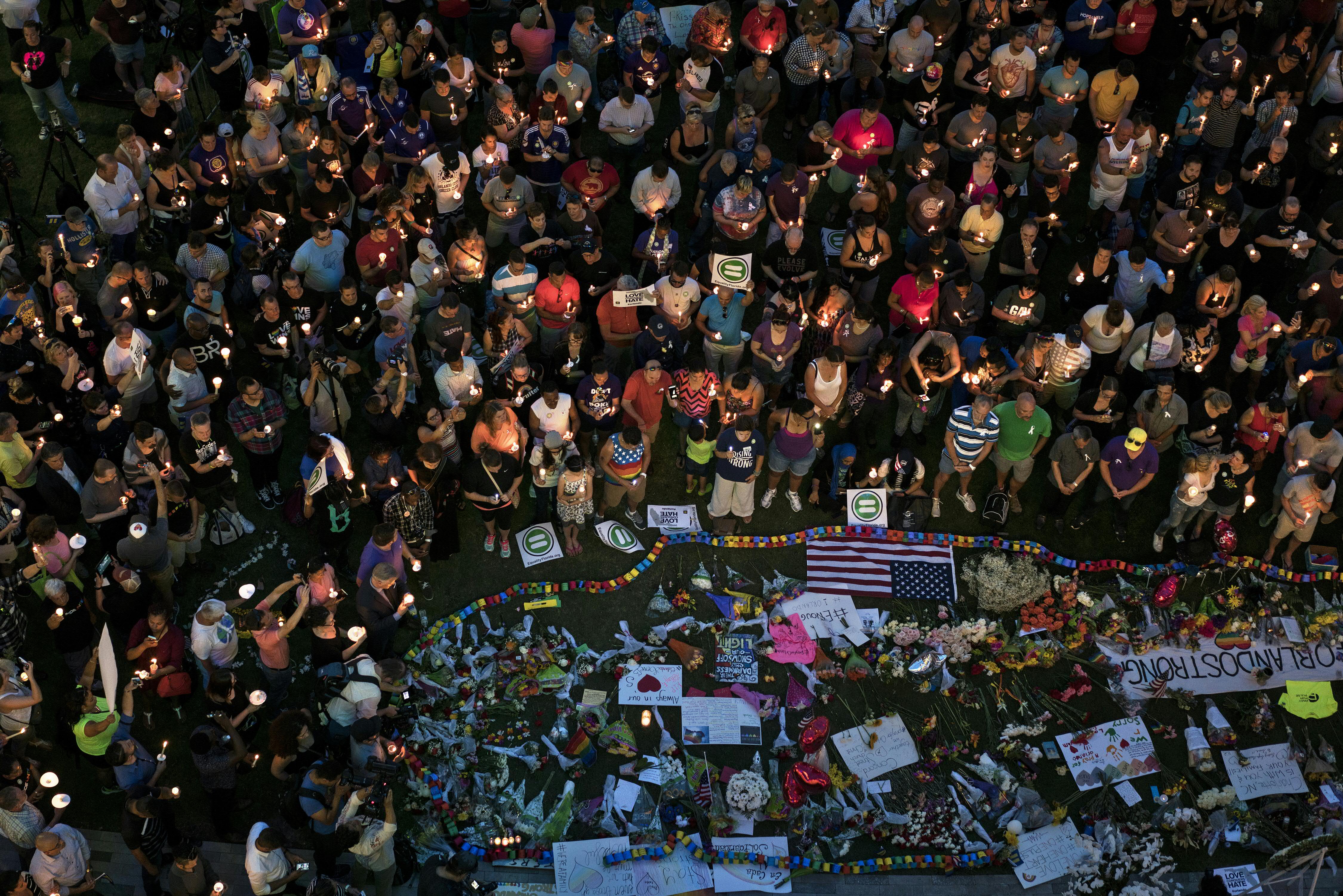 Mourners observing a moment of silence during a vigil for the mass shooting victims at the Pulse nightclub in Orlando