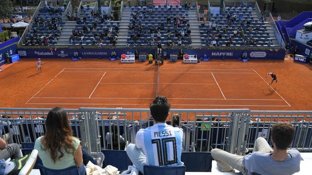 A spectator wearing a football jersey of Argentina's forward Lionel Messi attends the ATP Barcelona Open tennis tournament singles match between Japan's Kei Nishikori and Argentina's Guido Pella at the Real Club de Tenis in Barcelona 