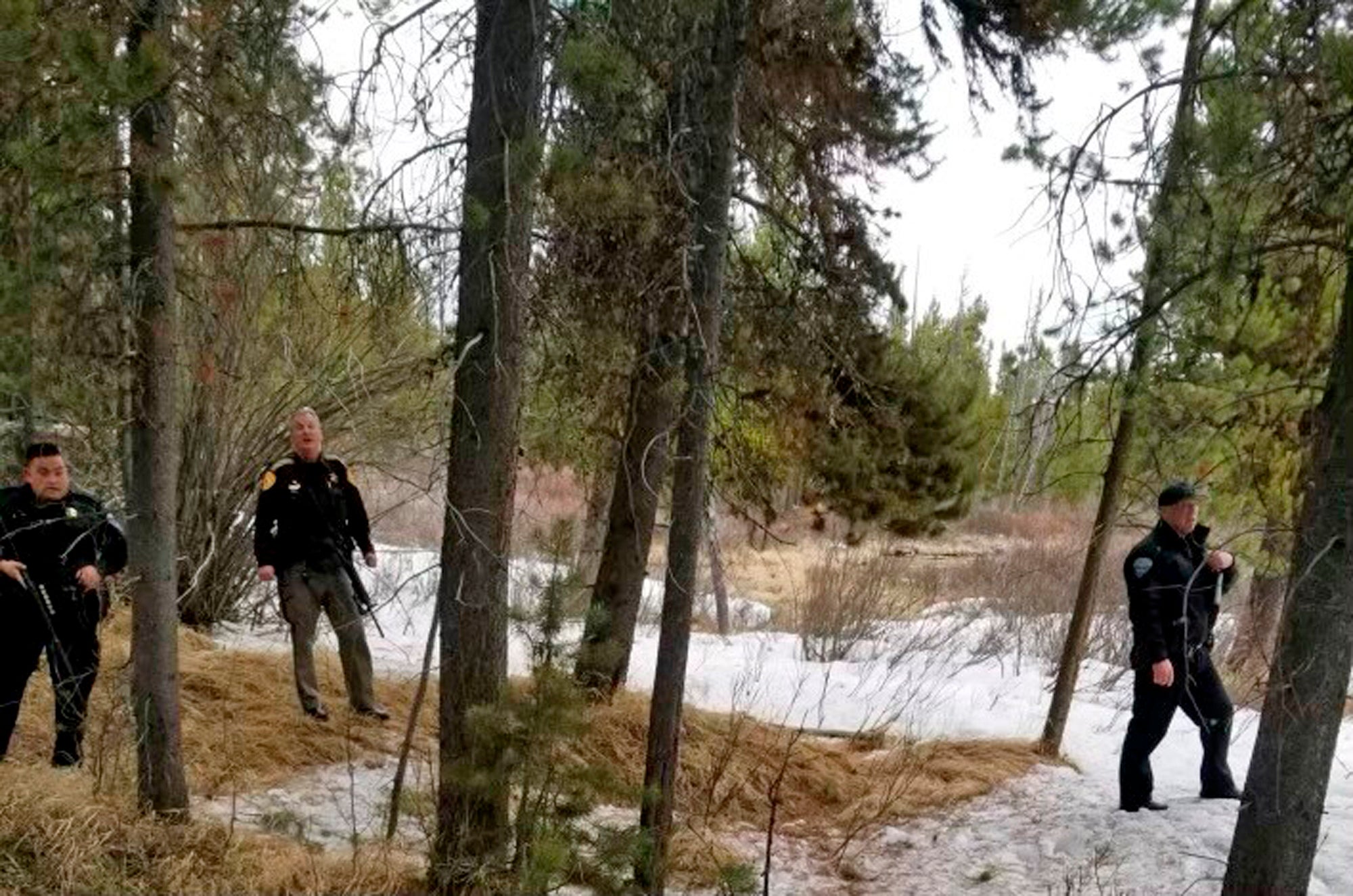 Police officers are seen near the site of a grizzly bear mauling just outside Yellowstone National Park in Montana. Authorities said Charles "Carl" Mock died on Saturday of injuries sustained in the attack