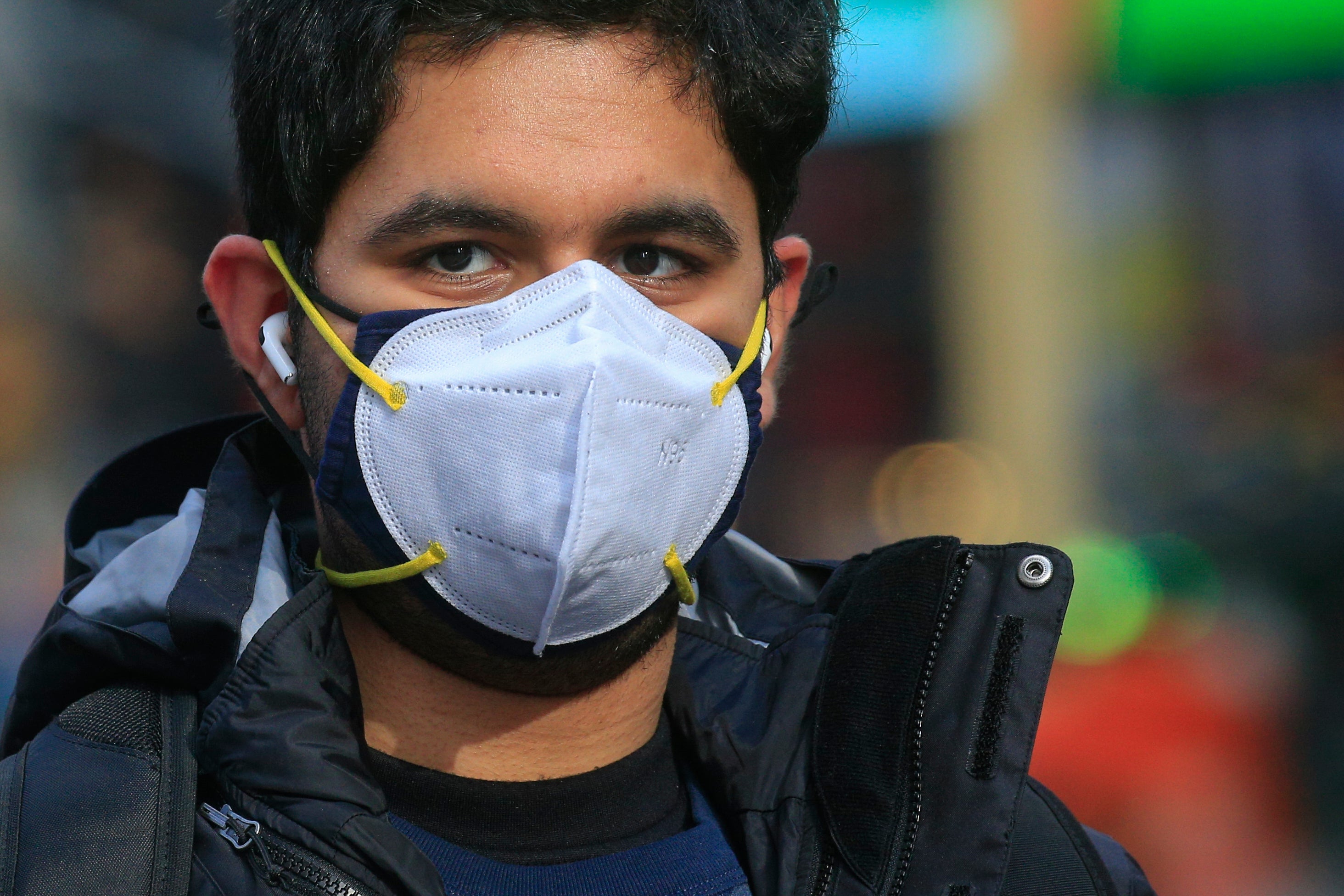 A man wears a double mask as he visits Times Square in New York