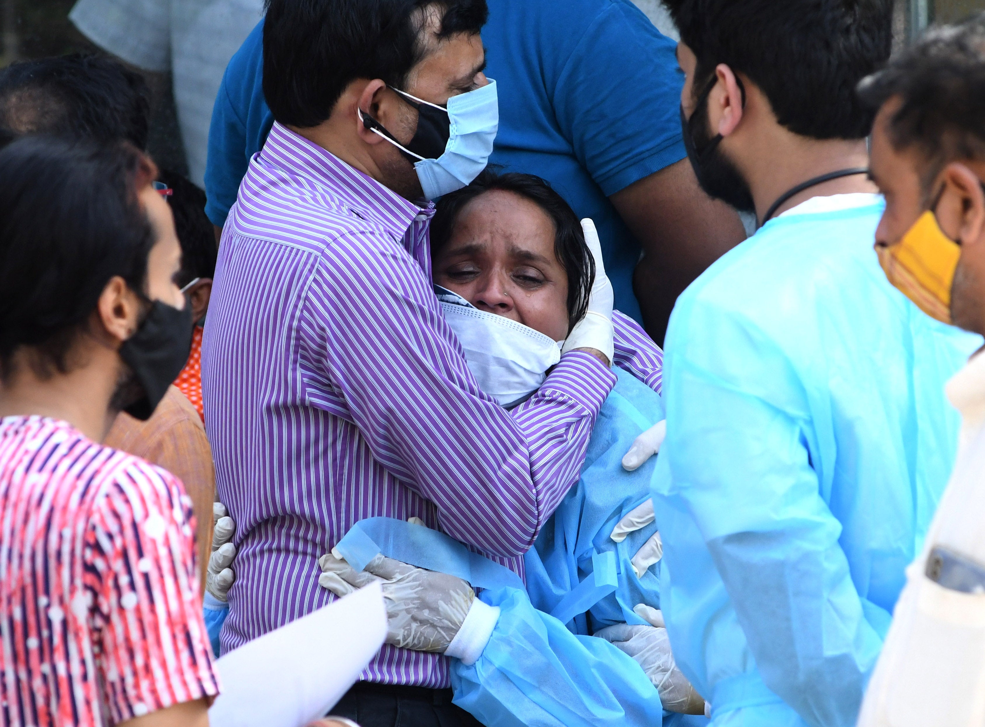 Relatives mourn during the last rites of a Covid-19 victim at a crematorium in New Delhi on Monday