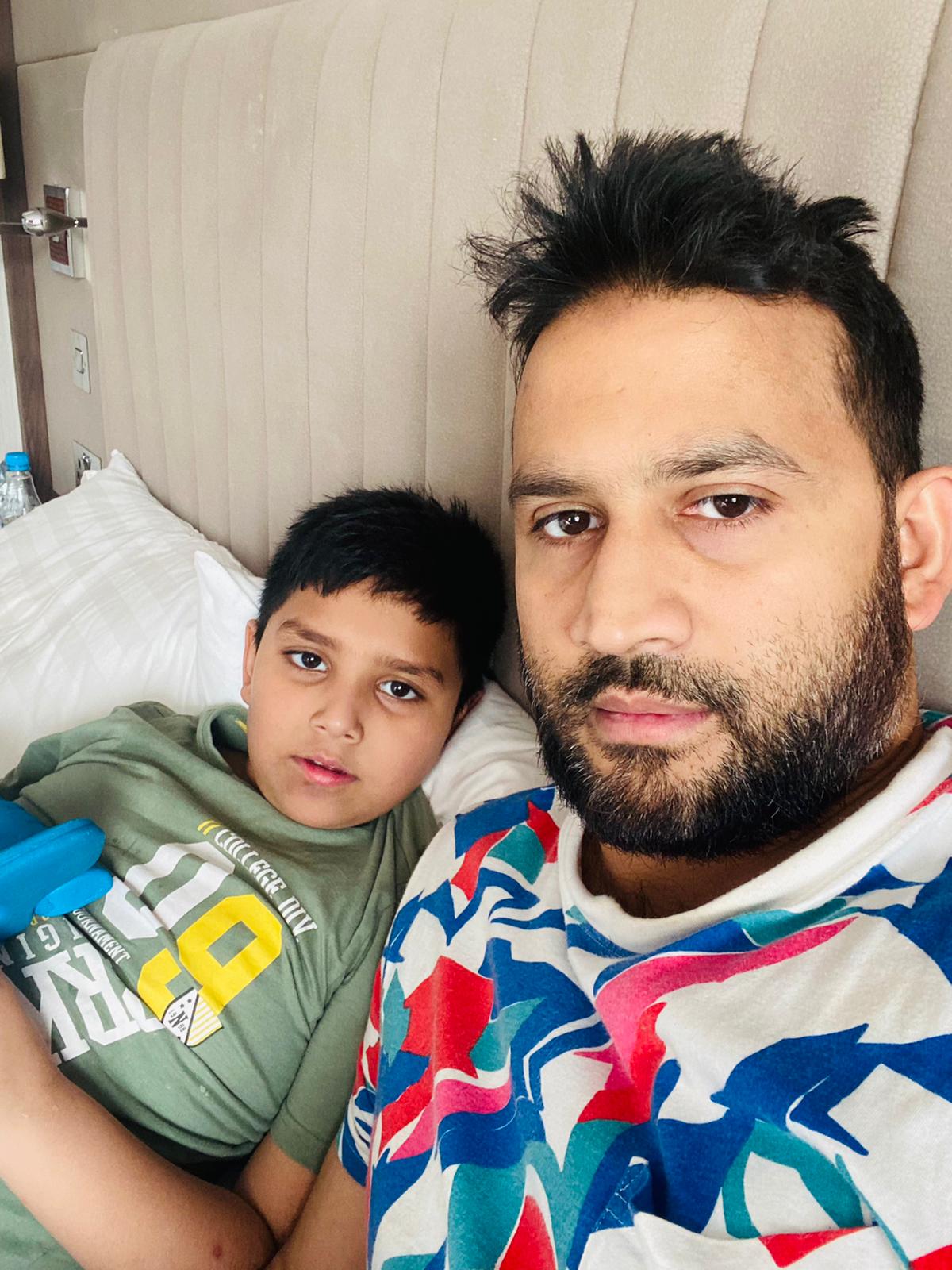 Mr Azam and his son, nine-year-old Ahmed, in their hotel room at the Crown Plaza