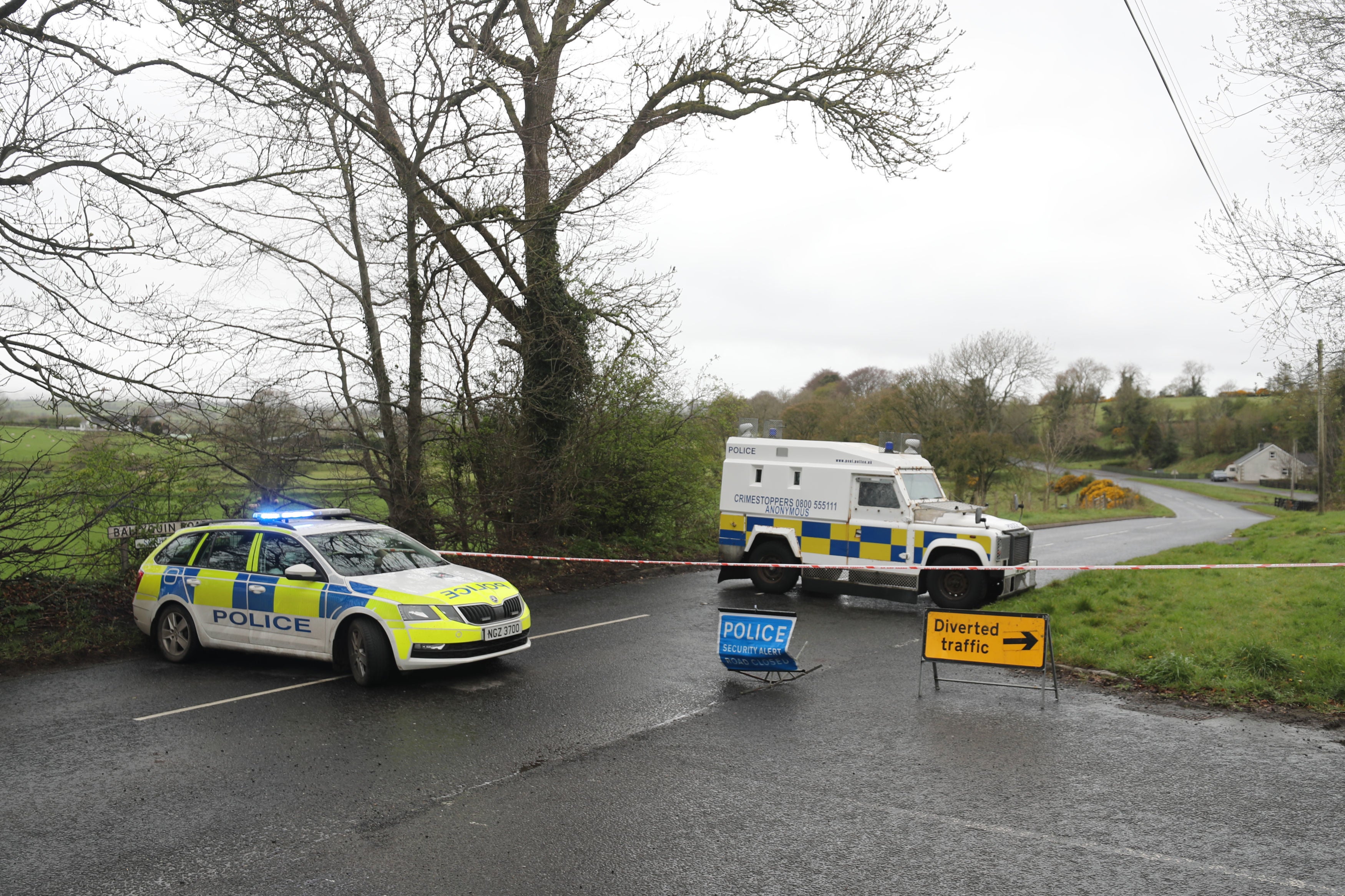 PSNI vehicles block a road after the explosive device was found in Dungiven