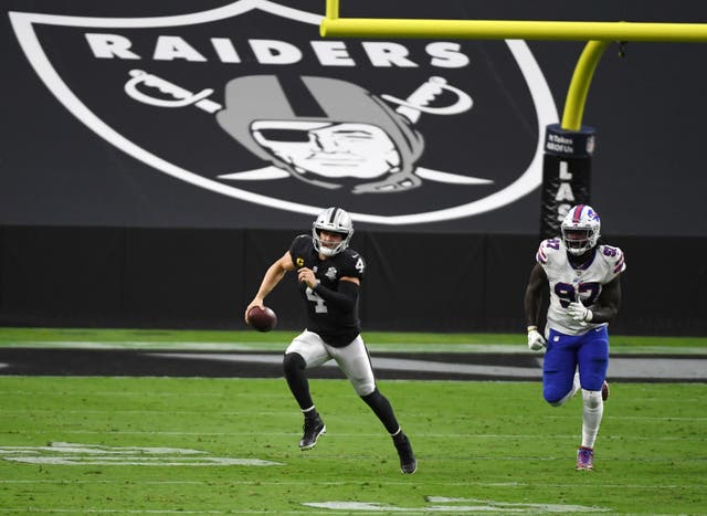 <p>Quarterback Derek Carr #4 of the Las Vegas Raiders is chased by defensive end Mario Addison #97 of the Buffalo Bills during the second half of the NFL game at Allegiant Stadium on October 4, 2020 in Las Vegas, Nevada. </p>