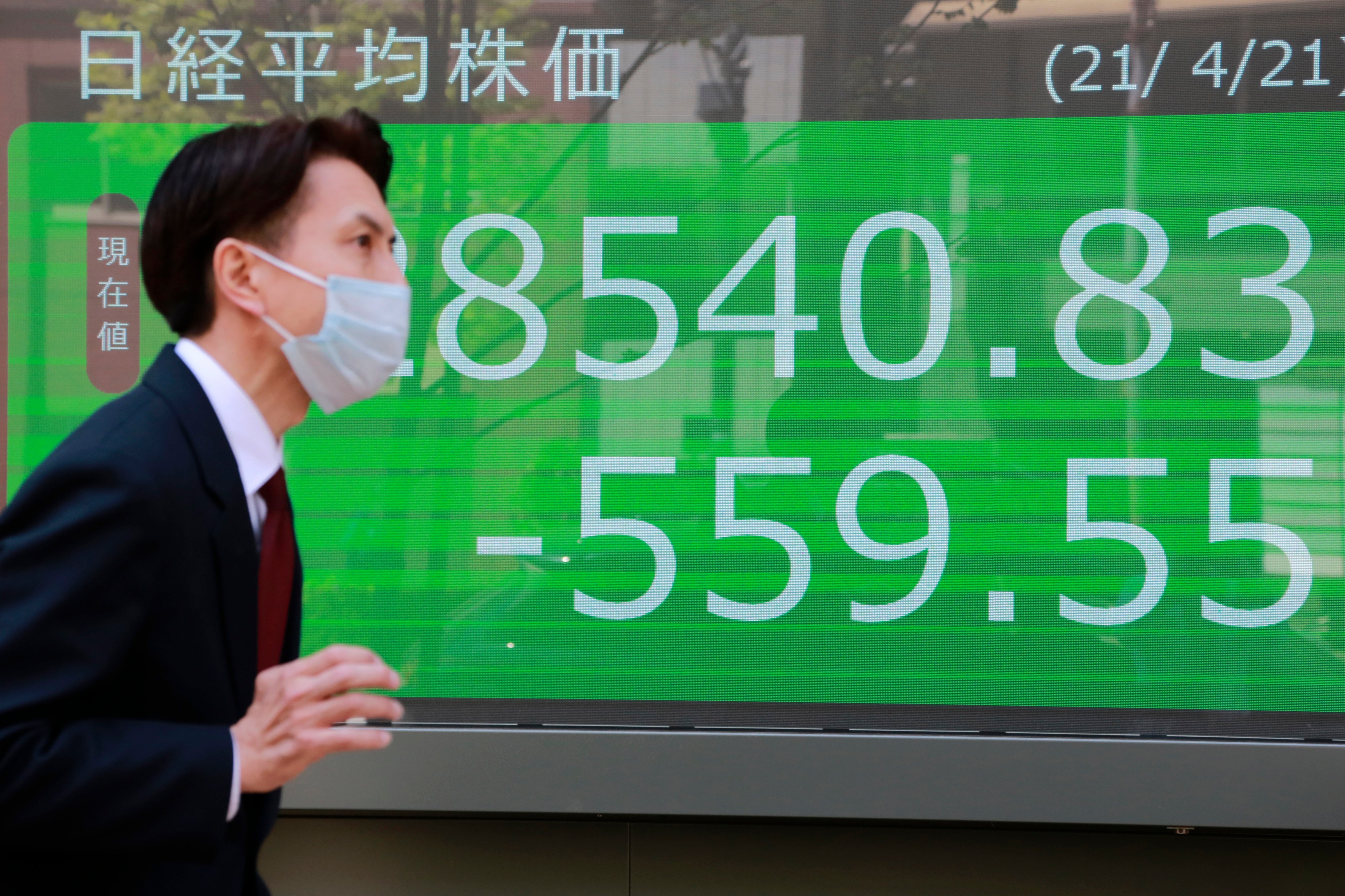 A man reads Asia-Pacific shares in a mixed trading day after US stocks tumble (file image)