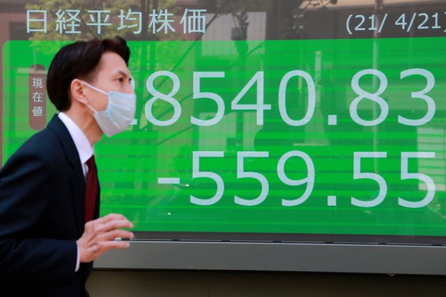 <p>A man reads Asia-Pacific shares in a mixed trading day after US stocks tumble (file image)</p>