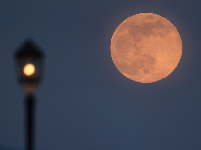  A supermoon rises over Worthing pier on 7 April, 2020 in Worthing, United Kingdom