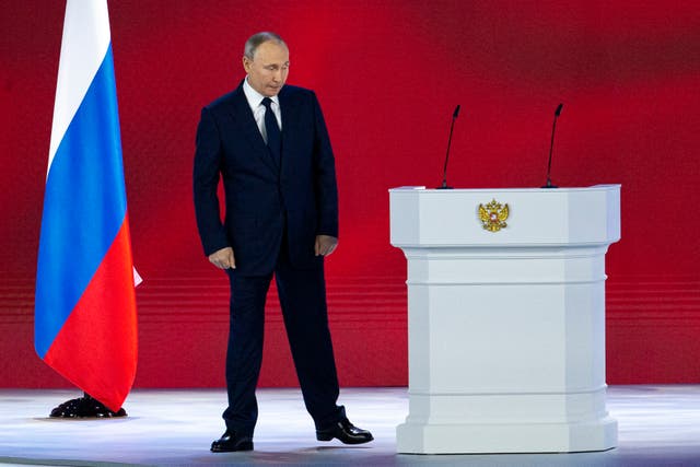 <p>Russian president Vladimir Putin leaves the hall after his annual state of the nation address today (21 April)</p>