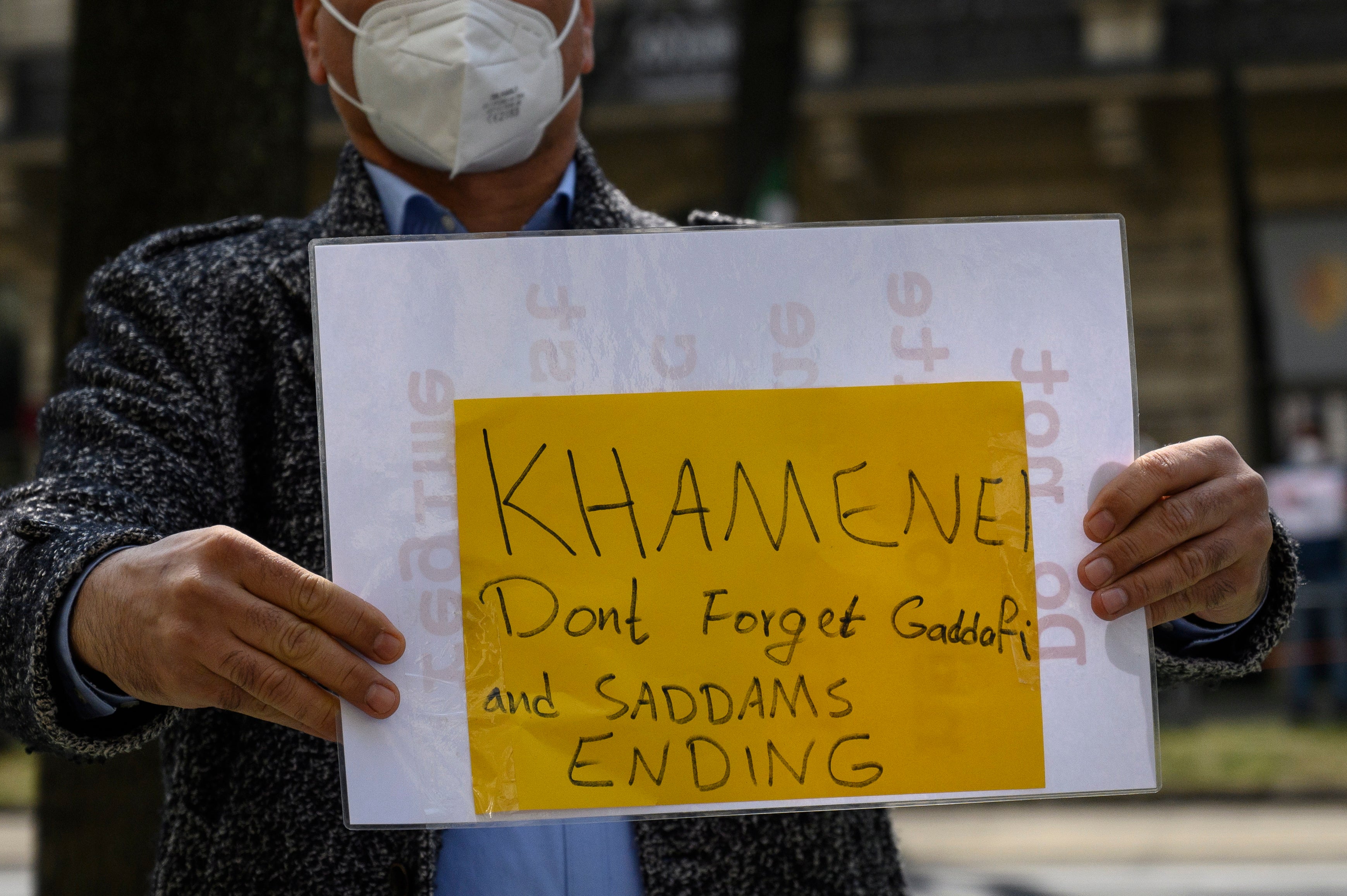A protester displays a banner outside the talks in Vienna