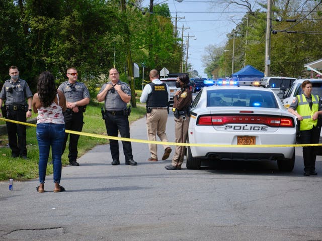 A resident, left, uses her cell phone to record video of police near the scene of a shooting, Wednesday, April 21, 2021 in Elizabeth City, N.C. 