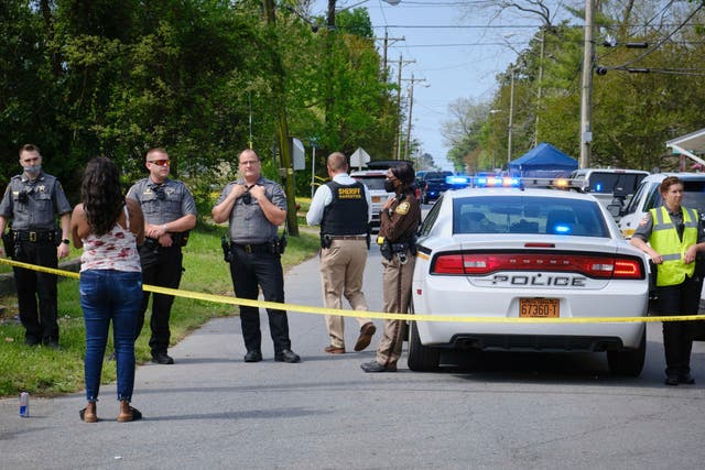 A resident, left, uses her cell phone to record video of police near the scene of a shooting, Wednesday, April 21, 2021 in Elizabeth City, N.C. 