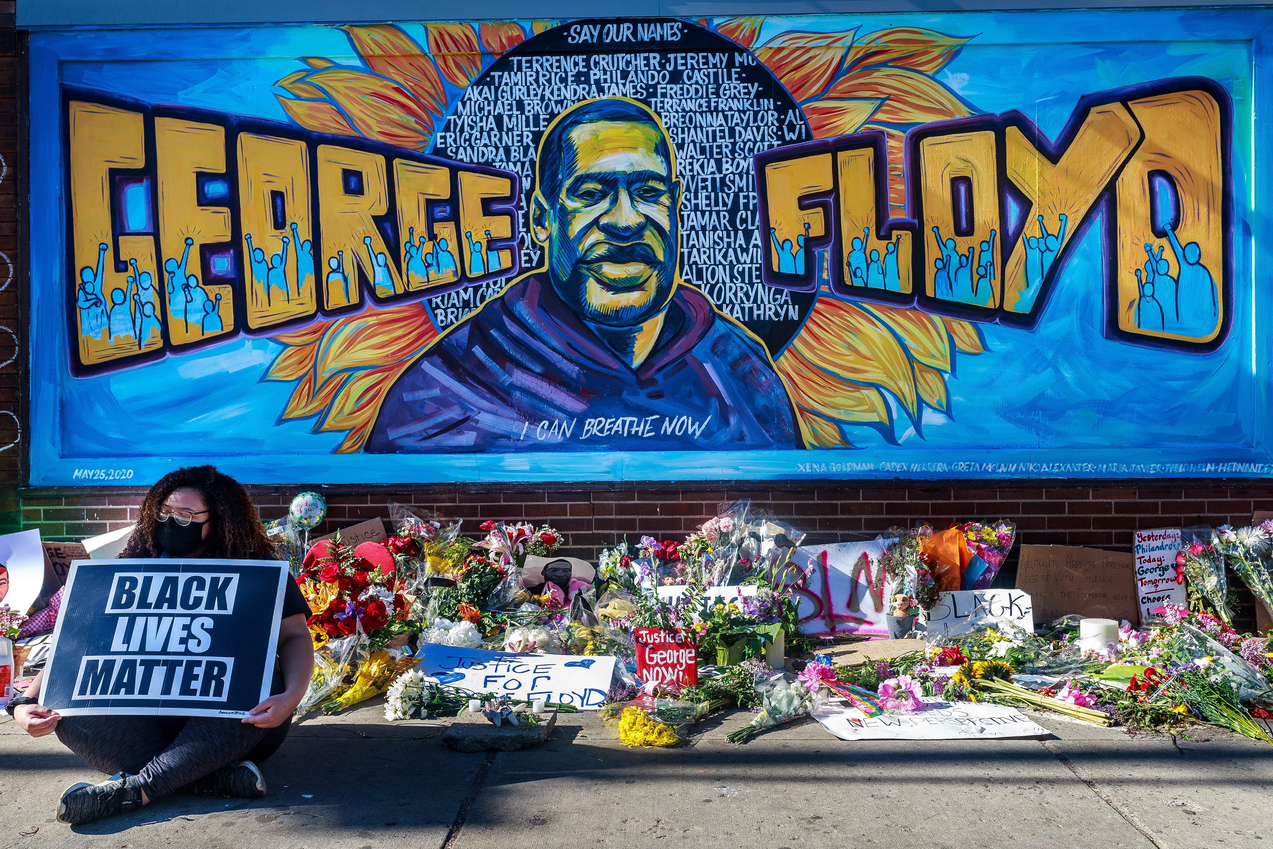 <p>Flowers, signs and balloons are left near a makeshift memorial to George Floyd near the spot where he died while in custody of the Minneapolis police, on May 29, 2020 in Minneapolis, Minnesota</p>