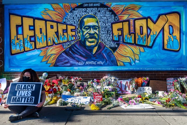 <p>Flowers, signs and balloons are left near a makeshift memorial to George Floyd near the spot where he died while in custody of the Minneapolis police, on May 29, 2020 in Minneapolis, Minnesota</p>