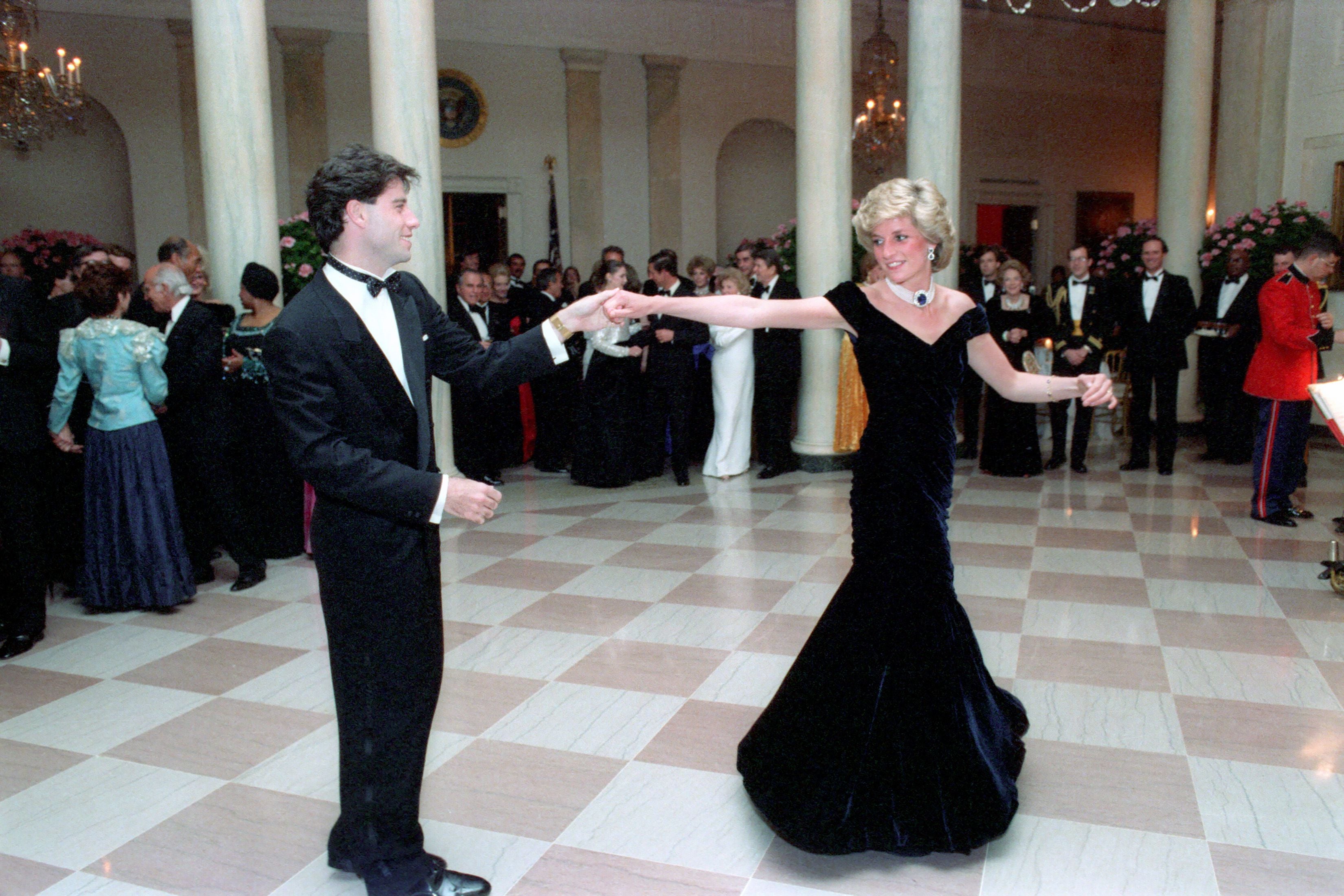 Princess Diana dancing with John Travolta at a White House dinner in 1985. The “Travolta Dress”, as it’s now know, recently went on display at Kensington Palace. Designed by Victor Edelstein, the midnight blue velvet dress featured off-the-shoulder straps, a floor-sweeping velvet skirt, a decorative bow and layers of tulle petticoats. The dress was bought by charity Historic Royal Palaces in December 2019 for£264,000 and has been in a specialist conservation facility since.