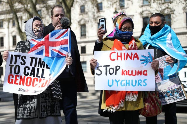 <p>People protest in London against the atrocities carried out by China in Xinjiang province. </p>