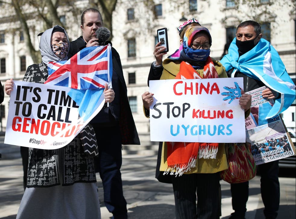<p>People protest in London against the atrocities carried out by China in Xinjiang province. </p>