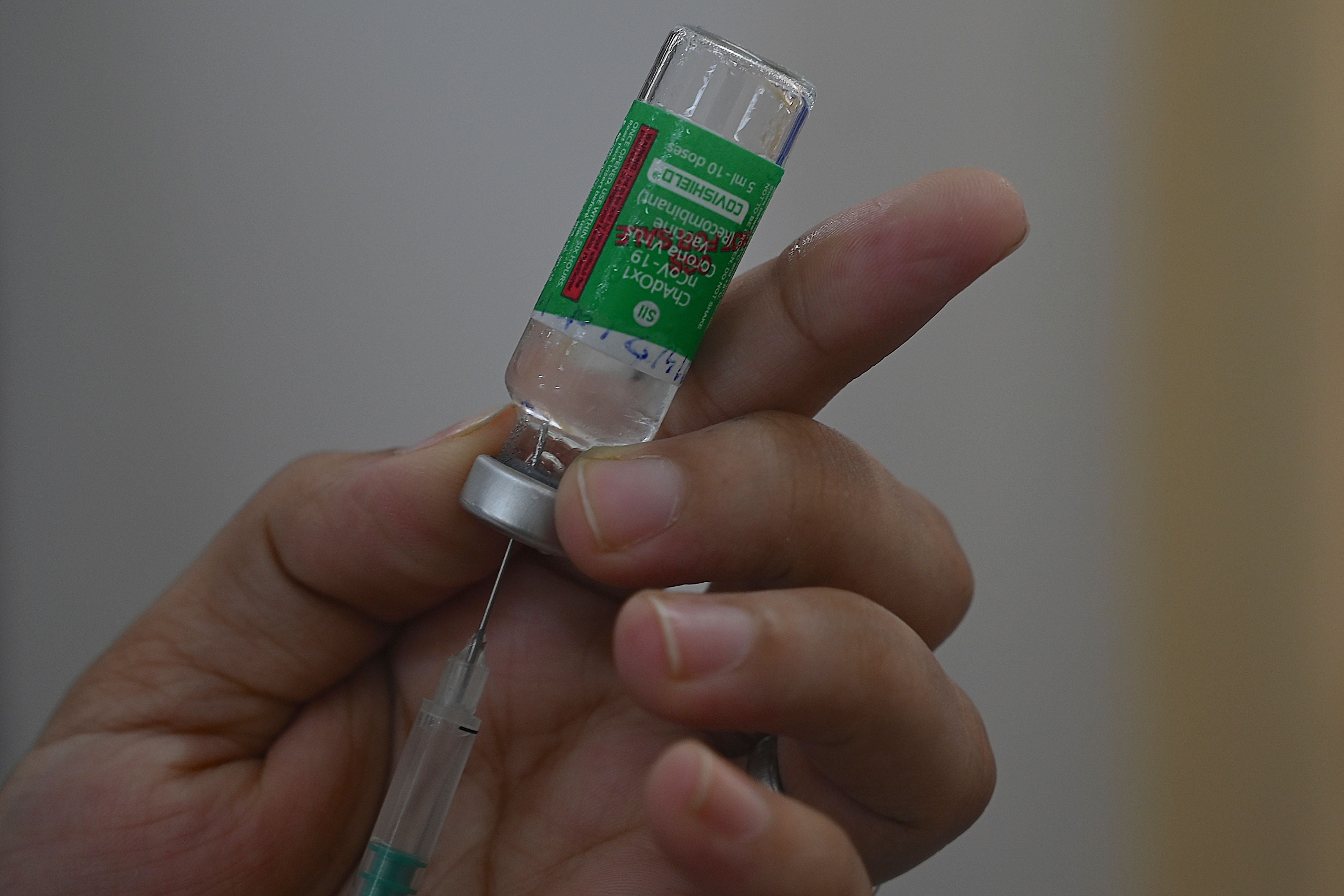 A medical staff fills a syringe with the Covishield at a vaccination centre in Mumbai on 19 April, 2021.