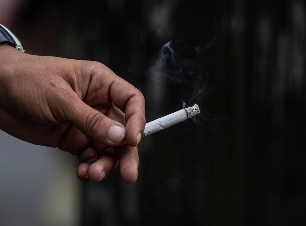 A man smokes a cigarette that was allegedly smuggled into Venezuela
