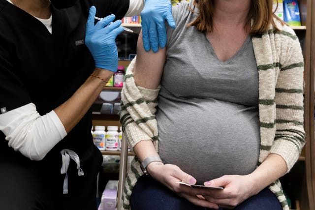 <p>A pregnant woman receives a Covid-19 vaccine in Pennsylvania</p>