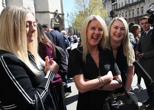 <p>Former post office worker Janet Skinner (centre), with her niece Hayley Adams (right) and her daughter Toni Sisson, celebrating outside the Royal Courts of Justice, London, after having her conviction overturned by the Court of Appeal</p>