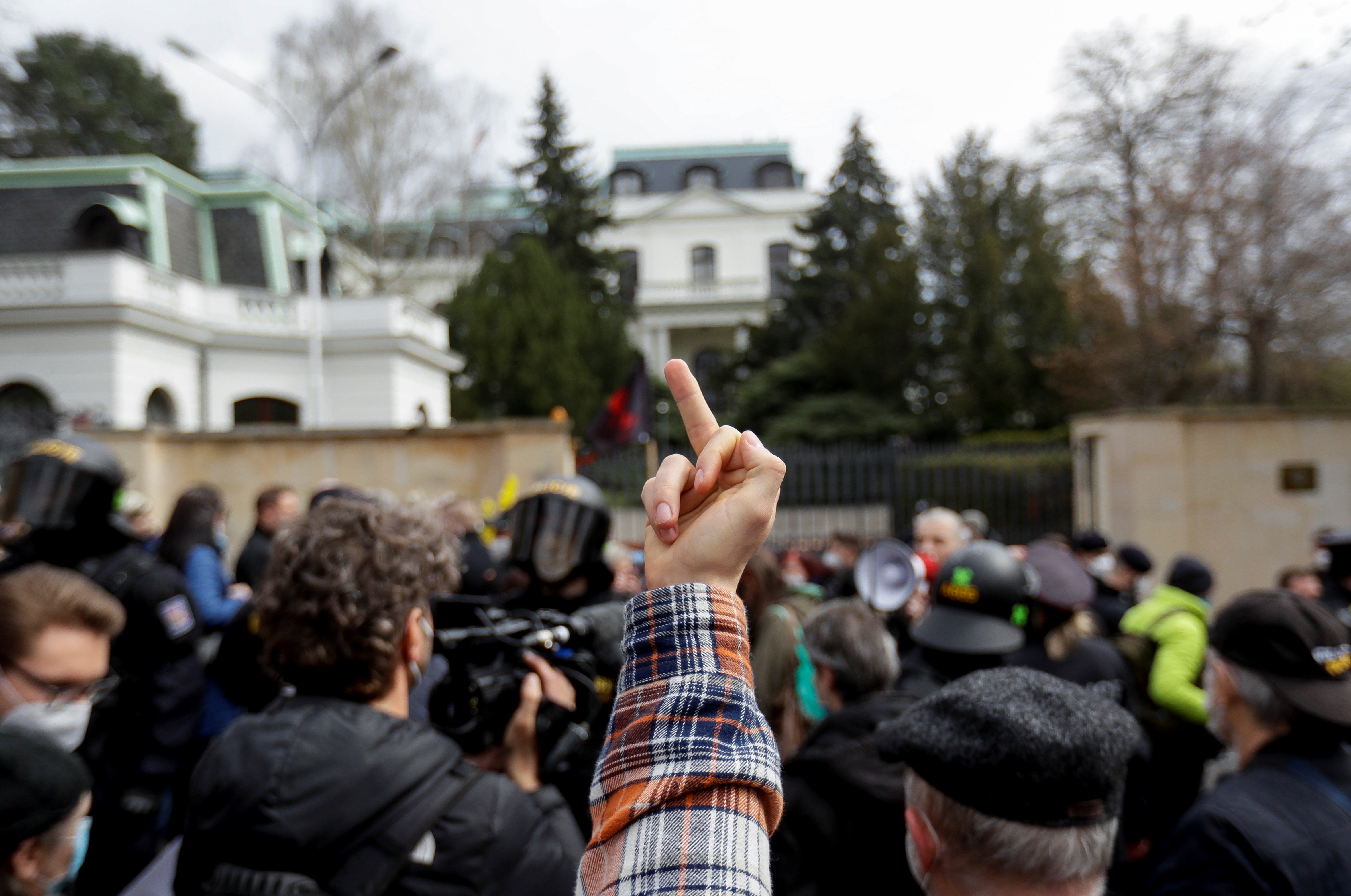 A person gestures during a protest outside the Russian Embassy in Prague