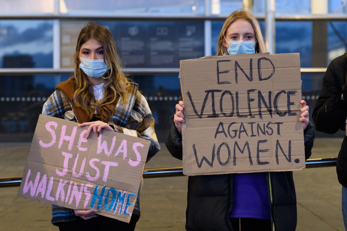 Women hold placards during a vigil for Sarah Everard
