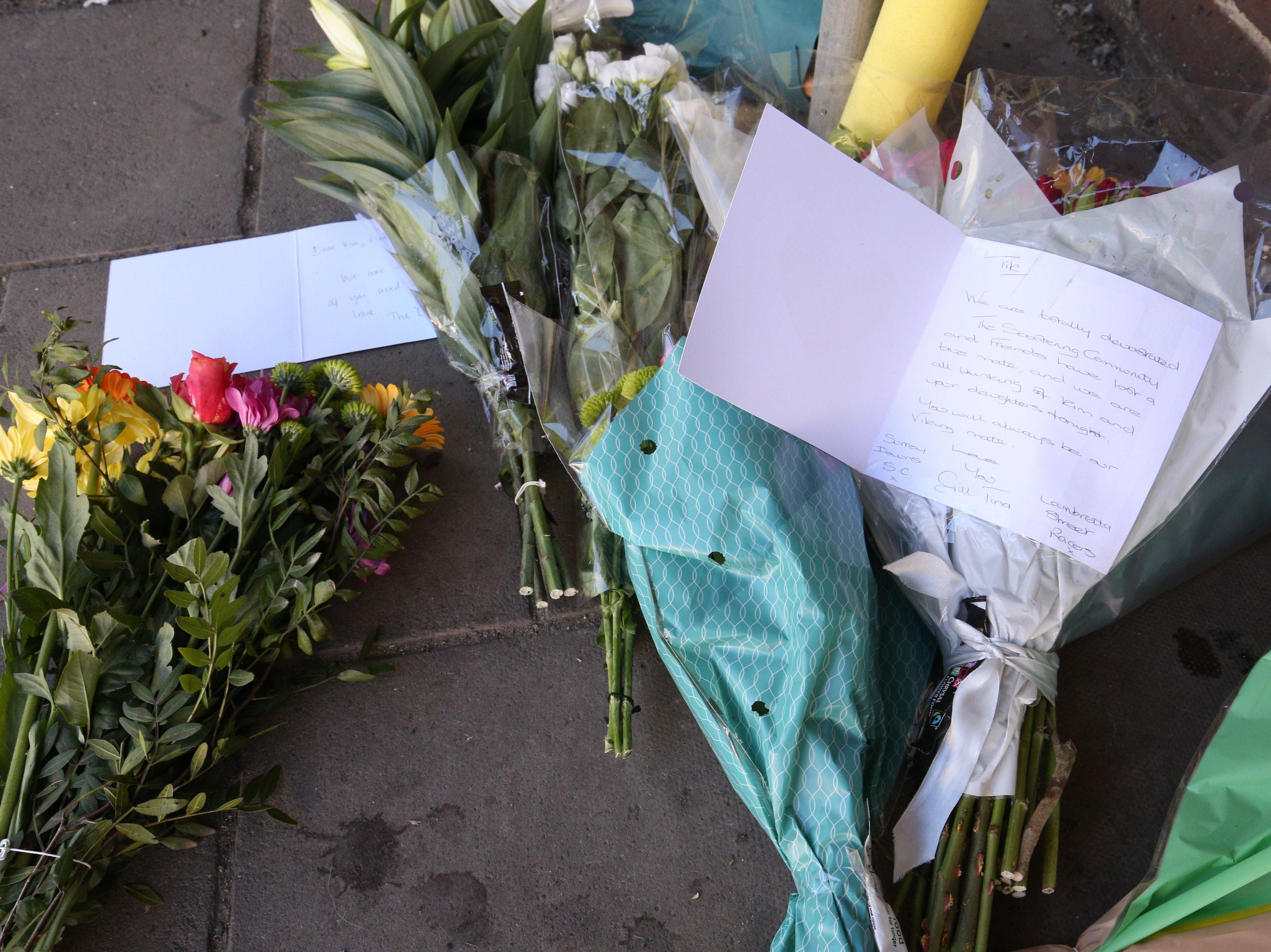 Floral tributes left at the scene near Church Street, Walton-on-Thames, Surrey, where a man died and another was airlifted to hospital after a car was reportedly driven at them