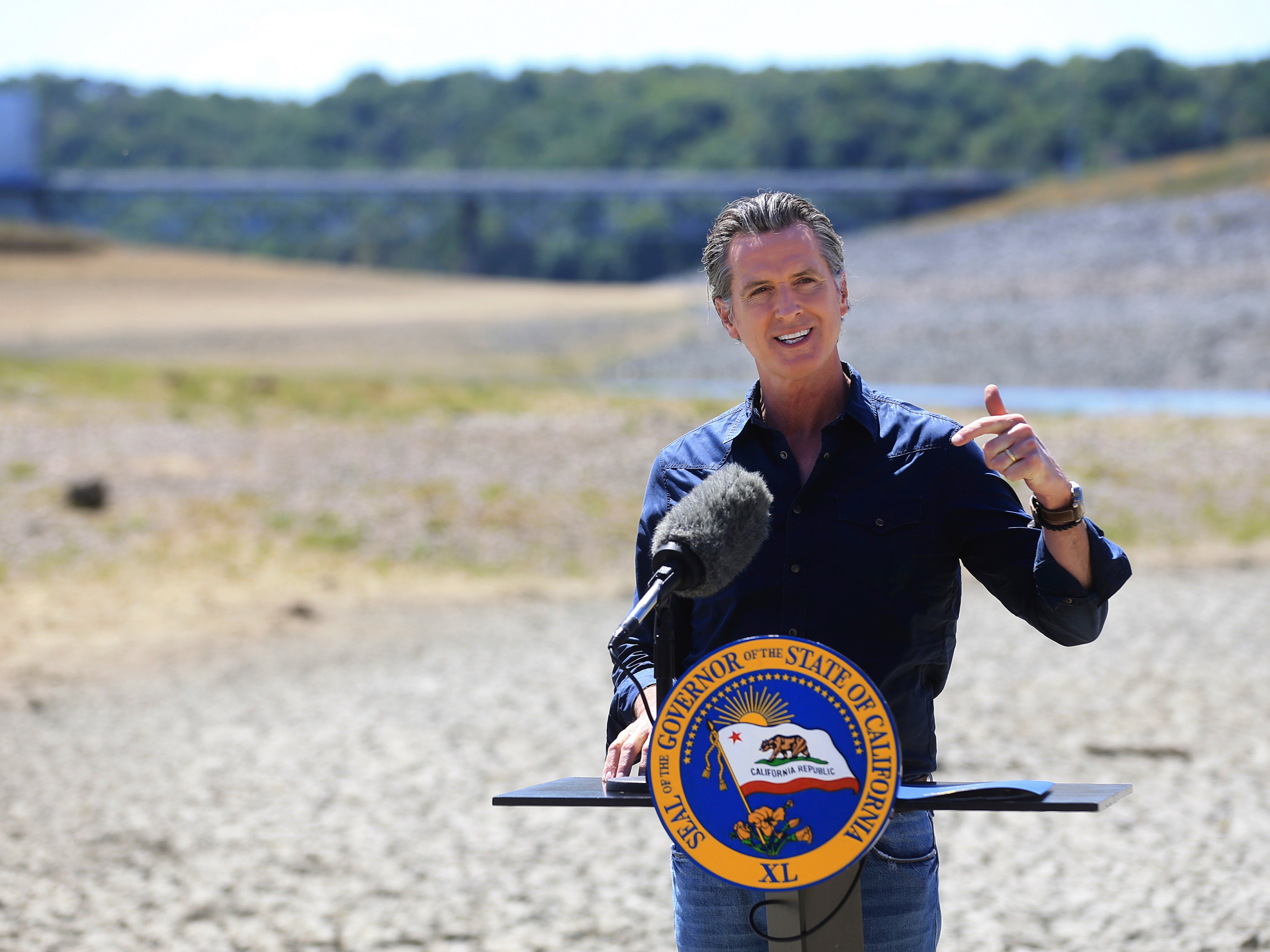 <p>California Gov Gavin Newsom speaks at a news conference in the parched basin of Lake Mendocino in Ukiah, California on Wednesday, 21 April 2021</p>