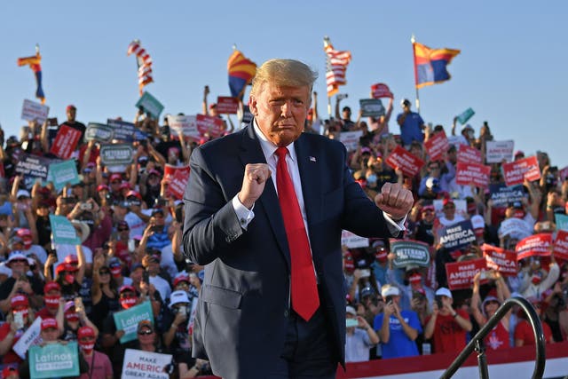 <p>US President Donald Trump dances as he leaves a rally at Tucson International Airport in Tucson, Arizona on October 19, 2020.</p>