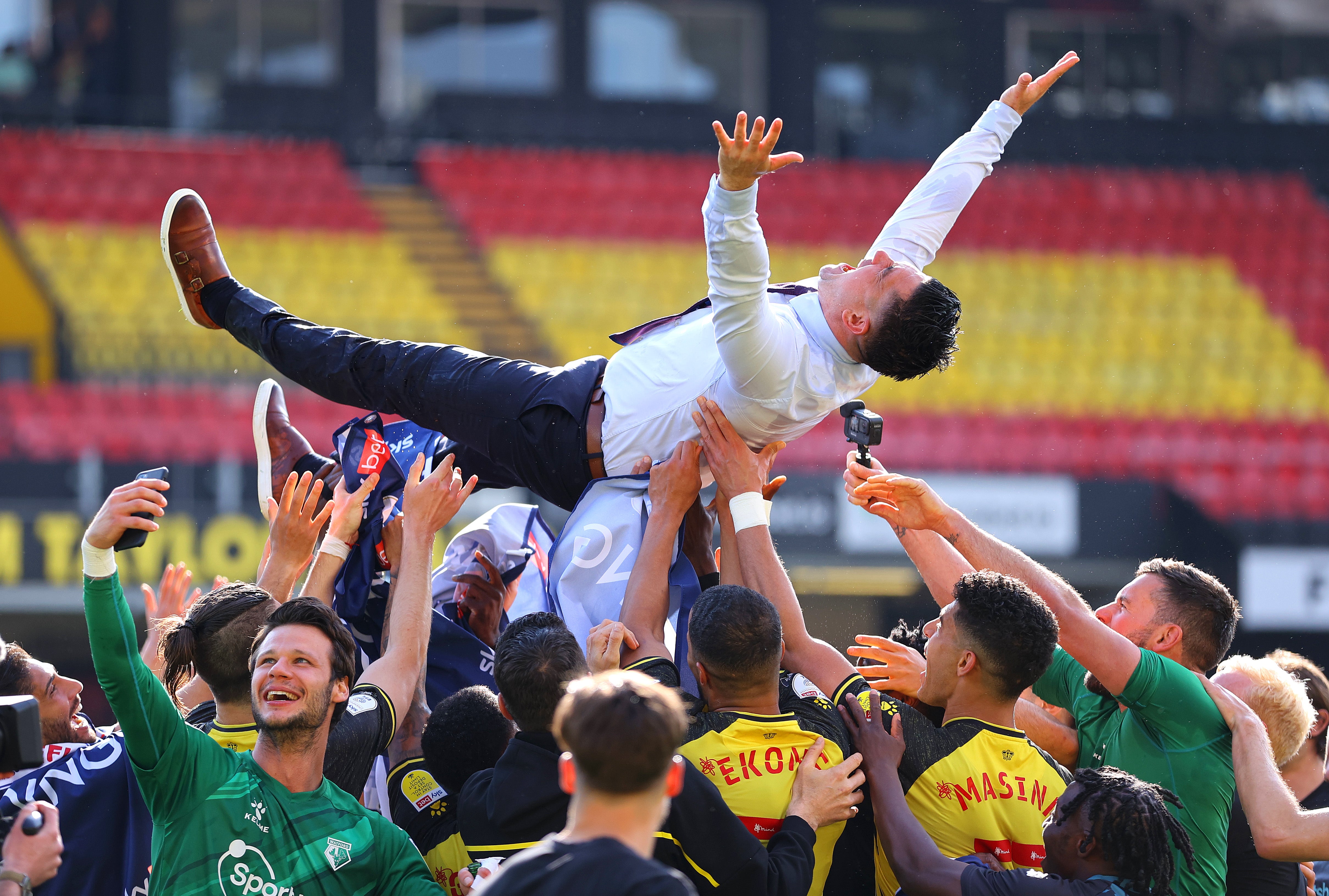 Xisco Munoz is thrown into the air by his players after clinching promotion