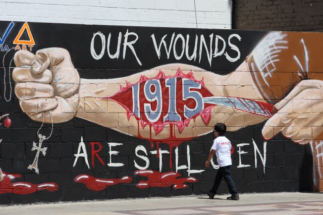 <p>A boy looks at a mural commemorating the 1915 Armenian Genocide on Hollywood Boulevard near a rally on the 99th anniversary of the event, calling for recognition and reparations, on April 24, 2014 in Los Angeles, California. </p>