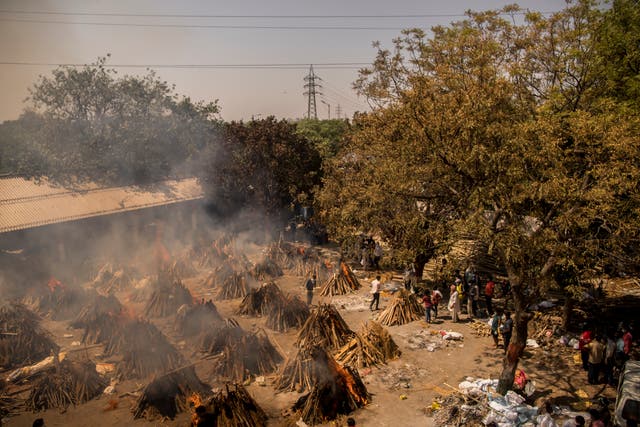 <p>A general view of multiple burning funeral pyres of patients who died of the Covid-19 coronavirus disease at a crematorium on April 24, 2021 in New Delhi, India. </p>