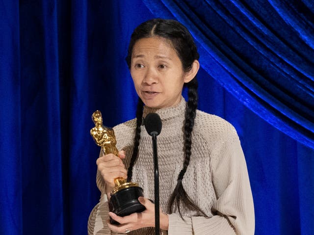 Chloe Zhao collecting the Best Director award